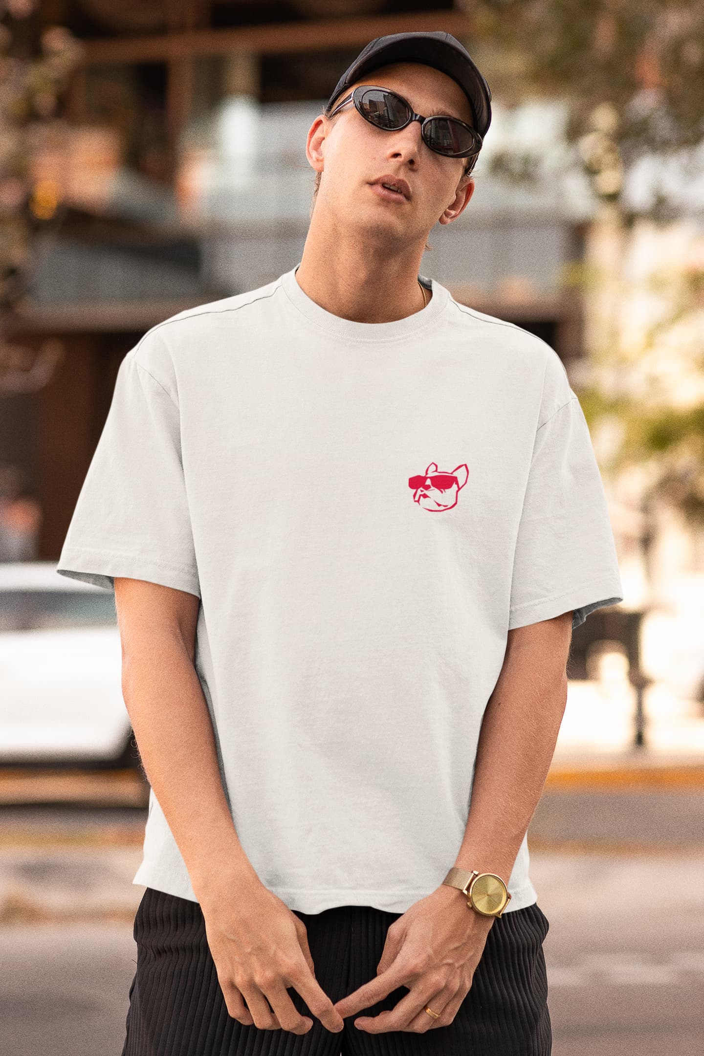 Front view of a white man with glasses wearing the white Be Bold T-shirt design that depicts the logo of the dog in red